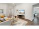Stylish living room with modern furniture, neutral colors, and a large screen television at 6708 162Nd E Pl, Parrish, FL 34219