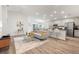 Open-concept living room and kitchen with recessed lighting, hardwood floors, and stainless steel appliances at 6708 162Nd E Pl, Parrish, FL 34219