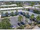 An aerial view of a condo building featuring multiple units and ample parking surrounded by tropical landscaping at 6713 Midnight Pass Rd # 4, Sarasota, FL 34242