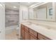 Bathroom featuring tile surround, vanity with storage, decorative mirror and ample countertop space at 6713 Midnight Pass Rd # 4, Sarasota, FL 34242