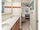 Bathroom leading into a bedroom, featuring a stylish sink, mirror, and décor accents at 6713 Midnight Pass Rd # 4, Sarasota, FL 34242