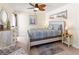 Nautical-themed bedroom with a decorative ceiling fan, stylish dresser, and ocean-themed artwork at 6713 Midnight Pass Rd # 4, Sarasota, FL 34242