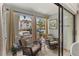 Enjoy outdoor living on this porch with cozy furniture and views of the landscaped surroundings at 6713 Midnight Pass Rd # 4, Sarasota, FL 34242