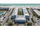 Beachfront condos featuring a pool, tropical landscaping, and a white sand beach at 7000 Gulf Dr # 205, Holmes Beach, FL 34217