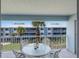 Cozy balcony view with a white patio set, perfect for enjoying outdoor relaxation at 7000 Gulf Dr # 205, Holmes Beach, FL 34217