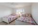 Bright bedroom featuring twin beds with colorful bedding and ample natural light at 7000 Gulf Dr # 205, Holmes Beach, FL 34217