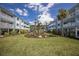 Well-maintained condo community featuring a manicured courtyard with tropical plants at 7000 Gulf Dr # 205, Holmes Beach, FL 34217