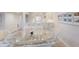 Bright dining area features a glass table, wicker chairs, and a view into the kitchen at 7000 Gulf Dr # 205, Holmes Beach, FL 34217