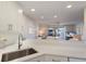 Kitchen view showcasing white countertops and a glimpse into the living area and outdoor balcony at 7000 Gulf Dr # 205, Holmes Beach, FL 34217