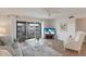 Bright living room with comfortable seating, wood floors, and balcony access at 7000 Gulf Dr # 205, Holmes Beach, FL 34217