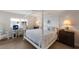 Light-filled bedroom featuring a four-poster bed and dedicated workspace at 7000 Gulf Dr # 205, Holmes Beach, FL 34217