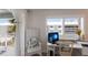Bright bedroom office space with a white desk, chair and balcony access at 7000 Gulf Dr # 205, Holmes Beach, FL 34217