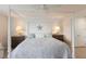 Well-lit bedroom featuring a four-poster bed with decorative lamps and side tables at 7000 Gulf Dr # 205, Holmes Beach, FL 34217