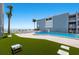 Exterior view of a pool with beach views and surrounding landscaping at 7000 Gulf Dr # 205, Holmes Beach, FL 34217