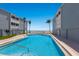 Large pool in a community with beach access and palm trees at 7000 Gulf Dr # 205, Holmes Beach, FL 34217
