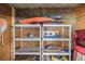 Well-organized storage area with shelving filled with beach gear and toys, ideal for beachside living at 7000 Gulf Dr # 205, Holmes Beach, FL 34217
