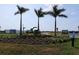 Entrance to the new community featuring a round-about with palm trees and signage at 721 Anegada Ln, Sarasota, FL 34234