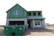 New construction home showing Zip System sheathing, window installation and a large trash container at 721 Anegada Ln, Sarasota, FL 34234