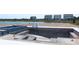 New pool construction with modern design and blue tiling near a pond and additional homes at 721 Anegada Ln, Sarasota, FL 34234