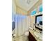 Cozy bathroom features a granite countertop, tile flooring, and updated vanity lighting at 7330 Kensington Ct, University Park, FL 34201