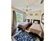 Comfortable bedroom boasts a ceiling fan, sliding glass doors to the yard, and hardwood floors at 7330 Kensington Ct, University Park, FL 34201