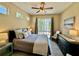 Comfortable bedroom features a ceiling fan, access to the yard, and a neutral color scheme at 7330 Kensington Ct, University Park, FL 34201