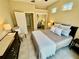 Neutral bedroom with an ensuite bathroom, double windows for natural light, and light tile flooring at 7330 Kensington Ct, University Park, FL 34201