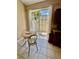 Cozy breakfast nook with a small table and view to a outdoor seating at 7330 Kensington Ct, University Park, FL 34201