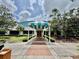 Beautiful exterior of building with awning and entryway surrounded by landscaping at 7330 Kensington Ct, University Park, FL 34201