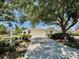Well-maintained single-story home with a two-car garage and mature trees at 7330 Kensington Ct, University Park, FL 34201