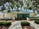 Beautiful exterior of building with tile roof, large glass windows, and manicured landscaping at 7330 Kensington Ct, University Park, FL 34201
