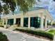 Exterior of building with windows, columns, and tiled roof surrounded by landscaping at 7330 Kensington Ct, University Park, FL 34201