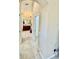 Hallway leading to bathroom showcasing neutral walls and tile flooring at 7330 Kensington Ct, University Park, FL 34201