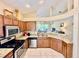 Open kitchen layout with stainless steel appliances and granite countertops perfect for entertaining at 7330 Kensington Ct, University Park, FL 34201