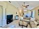 Open-concept living area with vaulted ceilings and neutral tile flooring at 7330 Kensington Ct, University Park, FL 34201