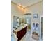 Bathroom featuring a stylish vanity, glass-enclosed shower, and neutral décor at 7330 Kensington Ct, University Park, FL 34201
