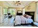 Comfortable main bedroom featuring a tray ceiling, decorative accents and access to outdoor space at 7330 Kensington Ct, University Park, FL 34201
