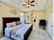 Spacious main bedroom with a tray ceiling and decorative accents creating a cozy atmosphere at 7330 Kensington Ct, University Park, FL 34201