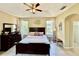 Elegant main bedroom with tray ceiling, and stylish décor creates a serene and inviting retreat at 7330 Kensington Ct, University Park, FL 34201