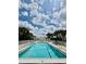 Large community pool with lots of seating and landscaping at 7330 Kensington Ct, University Park, FL 34201