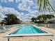 Gorgeous community pool with ample seating, a pergola, and landscaping at 7330 Kensington Ct, University Park, FL 34201