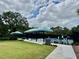 Community tennis court with shaded seating and ample parking at 7330 Kensington Ct, University Park, FL 34201