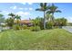 Wide shot of a well-manicured backyard and fence. Tropical landscaping is featured at 7626 Double Pine Dr, Sarasota, FL 34240