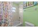 Bathroom featuring a tub with shower, colorful art and shower curtain at 7626 Double Pine Dr, Sarasota, FL 34240