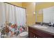 Cozy bathroom featuring colorful shower curtain, vanity, and white door at 7626 Double Pine Dr, Sarasota, FL 34240