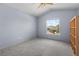 Neutral bedroom with vaulted ceiling and a view of the neighborhood through a large window, offering a serene space at 7626 Double Pine Dr, Sarasota, FL 34240