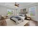 Beautiful bedroom with tray ceilings, wood floors, bed and natural light at 7626 Double Pine Dr, Sarasota, FL 34240