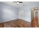 Clean bedroom features a ceiling fan, closet, neutral paint, and gorgeous hardwood floors at 7626 Double Pine Dr, Sarasota, FL 34240