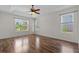 Primary bedroom featuring tray ceiling, ceiling fan, and wood-look flooring at 7626 Double Pine Dr, Sarasota, FL 34240