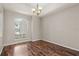 Dining area features hardwood floors, neutral paint, and an arch window that provides plenty of natural light at 7626 Double Pine Dr, Sarasota, FL 34240
